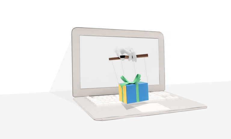 Laptop with hand emerging from the screen holding a gift box held by puppet strings.